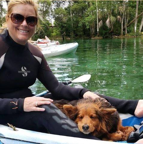 Kelly Cass boating with her dog.